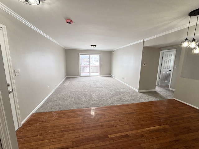 empty room featuring hardwood / wood-style flooring and crown molding