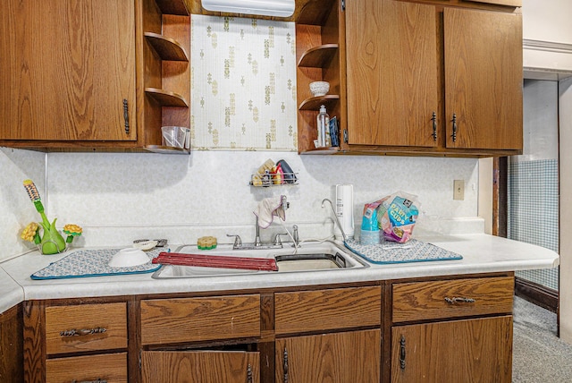 kitchen featuring brown cabinetry, tasteful backsplash, light countertops, and open shelves