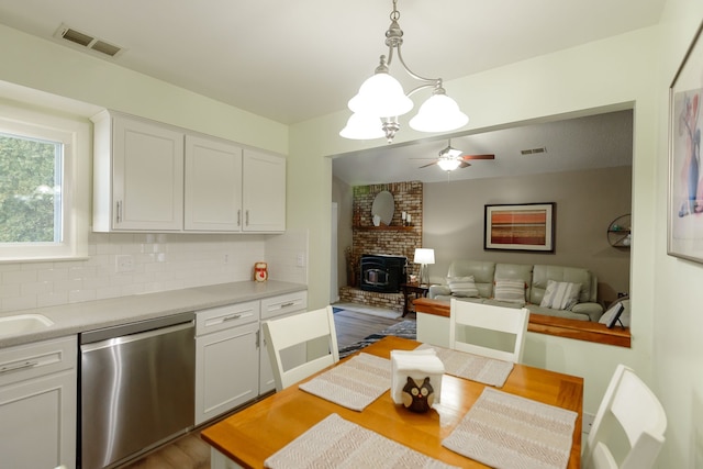 kitchen featuring white cabinetry, ceiling fan, dishwasher, decorative backsplash, and pendant lighting