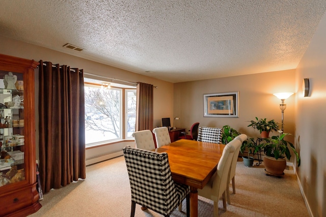 carpeted dining space featuring baseboard heating and a textured ceiling