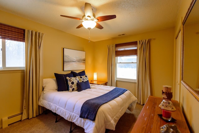 bedroom featuring ceiling fan, carpet floors, a textured ceiling, and a baseboard radiator