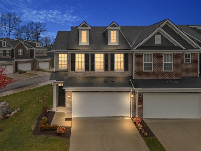 view of property featuring a garage and a yard