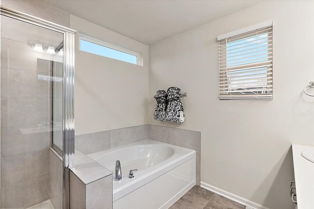 bathroom featuring independent shower and bath