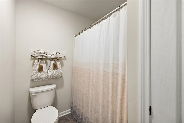 bathroom with walk in shower and toilet