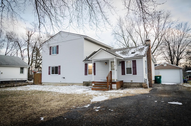 view of front facade featuring a garage and an outdoor structure