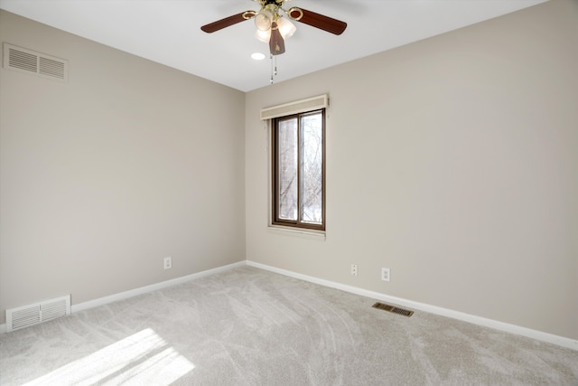 empty room with light colored carpet and ceiling fan