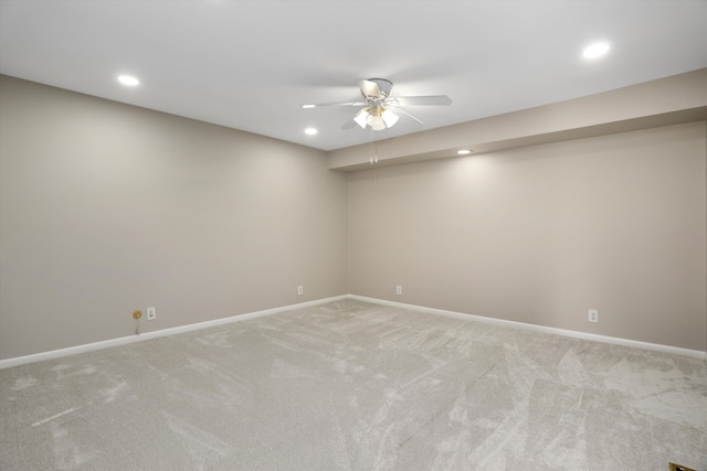 carpeted spare room featuring ceiling fan