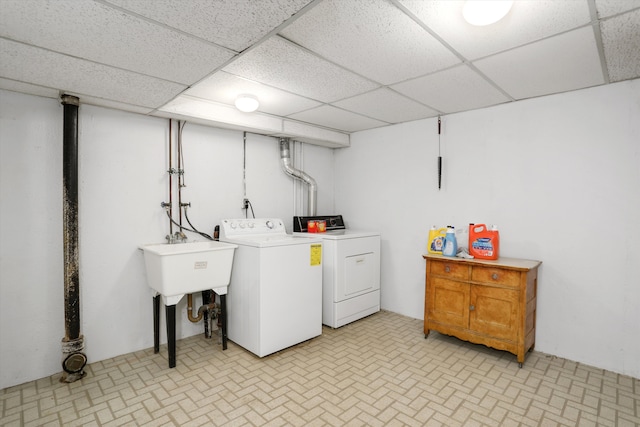 clothes washing area featuring sink and washing machine and clothes dryer