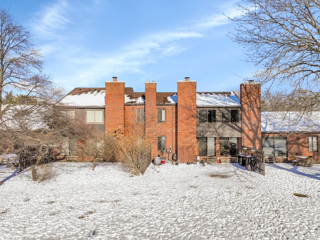 view of snow covered rear of property