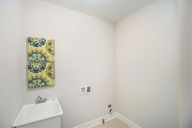 laundry area featuring washer hookup and light tile patterned floors