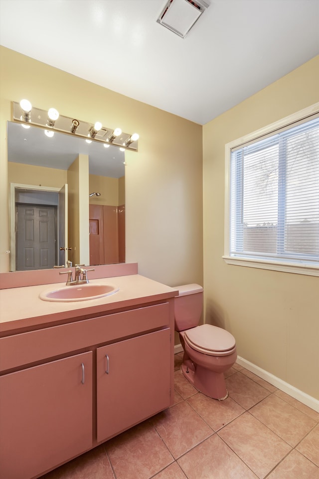 bathroom featuring tile patterned flooring, vanity, and toilet