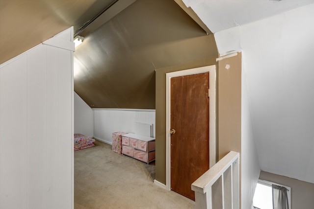 bonus room featuring lofted ceiling and light carpet