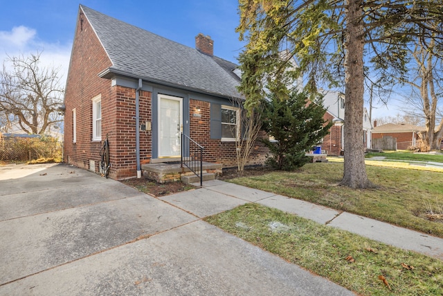 bungalow-style home featuring a front yard