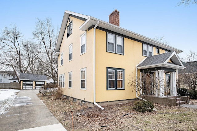 view of home's exterior featuring an outbuilding and a garage