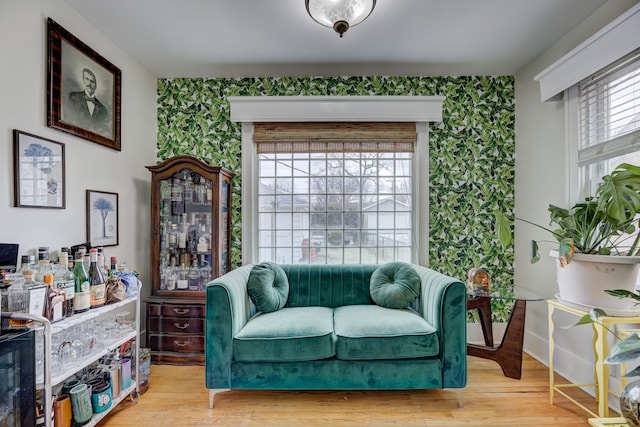 sitting room featuring light wood-style floors and wallpapered walls