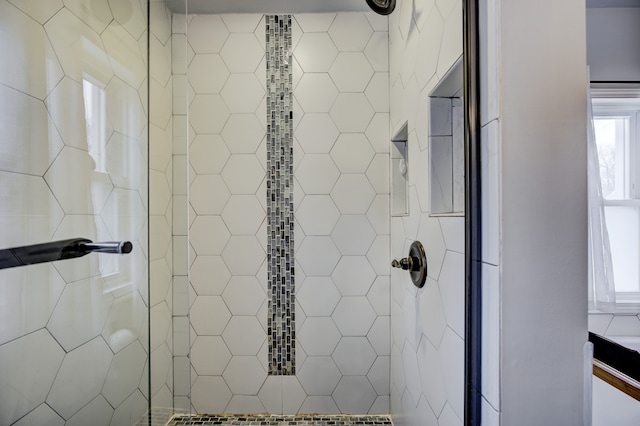 bathroom with plenty of natural light and a tile shower