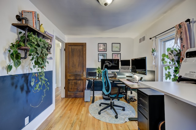 home office featuring light wood-style floors and visible vents