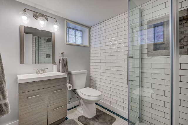 bathroom featuring tile patterned flooring, a shower stall, toilet, and vanity