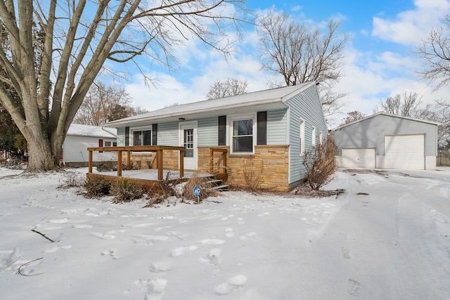 view of front of home with a garage and an outbuilding