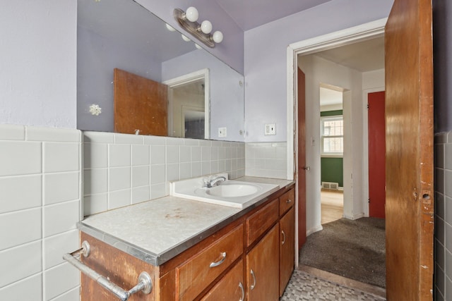 bathroom featuring vanity and tile walls