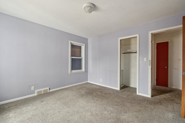 unfurnished bedroom with a closet and carpet flooring