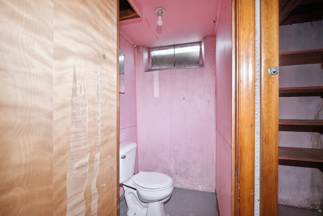 bathroom featuring toilet and concrete floors