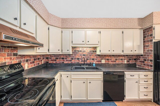 kitchen featuring sink, ventilation hood, black appliances, and cream cabinets