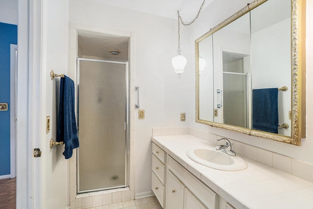 bathroom featuring walk in shower and vanity