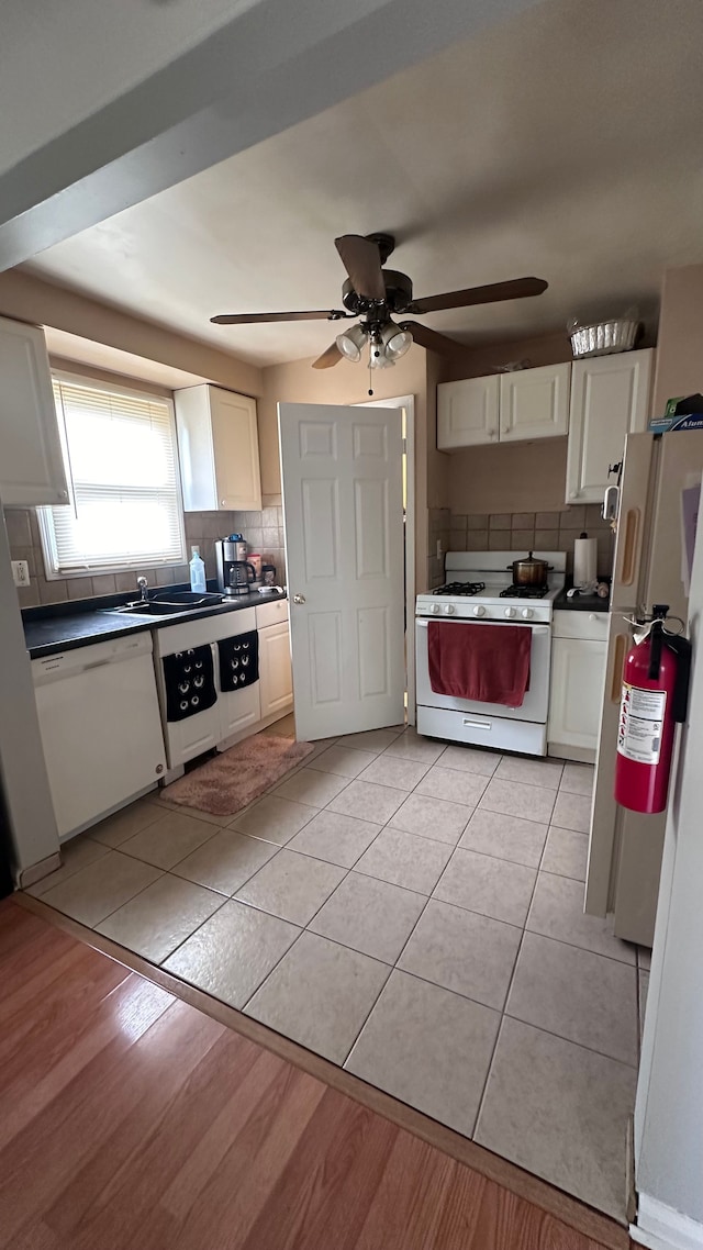 kitchen with white cabinets, white appliances, and decorative backsplash