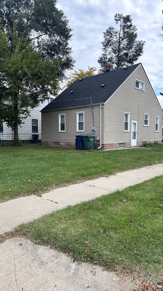 view of side of home featuring a lawn