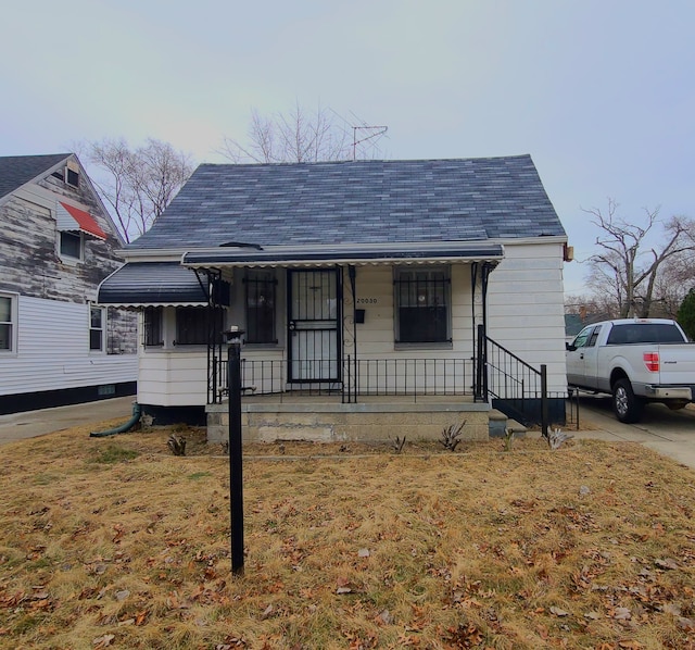 bungalow-style house with a front lawn and a porch