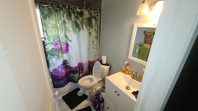 bathroom with vanity, tile patterned flooring, toilet, and walk in shower