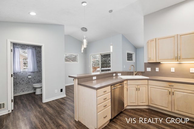 kitchen featuring lofted ceiling, a peninsula, a sink, dishwasher, and decorative light fixtures