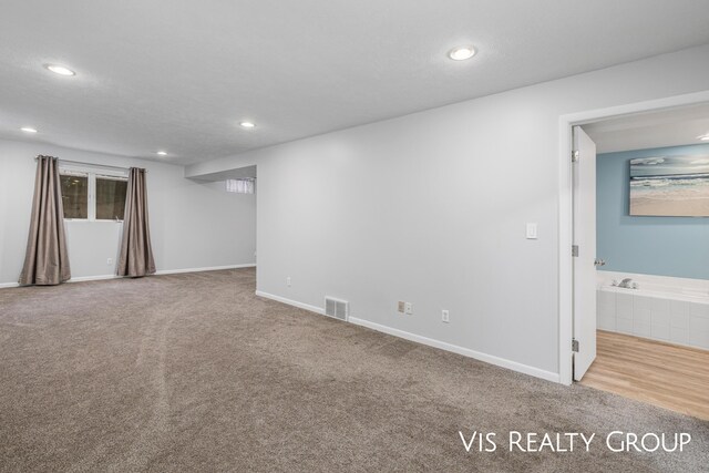 basement with recessed lighting, baseboards, visible vents, and carpet flooring