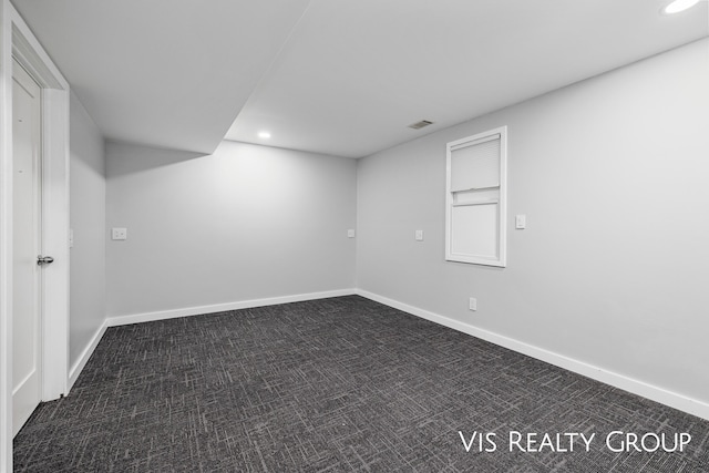 finished below grade area with recessed lighting, visible vents, dark carpet, and baseboards