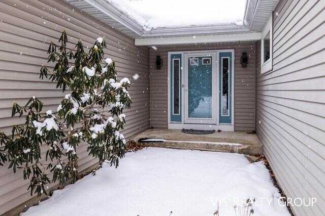 view of snow covered property entrance