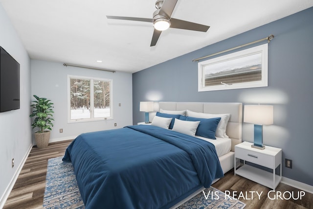 bedroom featuring a ceiling fan, dark wood-style flooring, and baseboards
