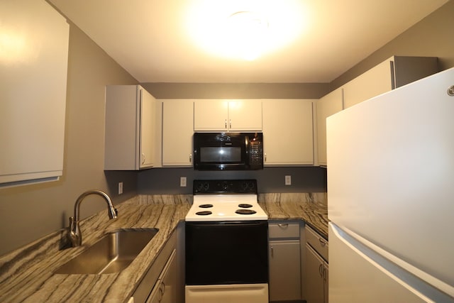 kitchen with white cabinetry, sink, dark stone countertops, white fridge, and electric stove