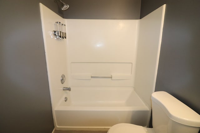 bathroom featuring tub / shower combination and toilet