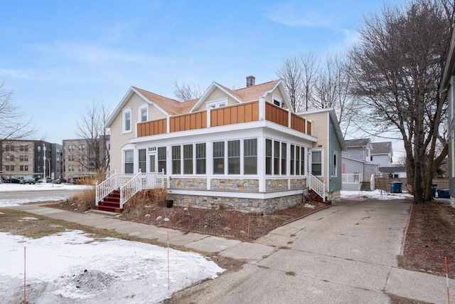 view of front of home with a sunroom