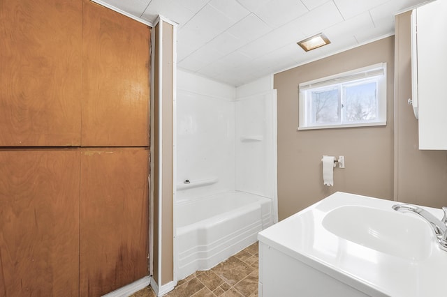 bathroom with bathing tub / shower combination and sink