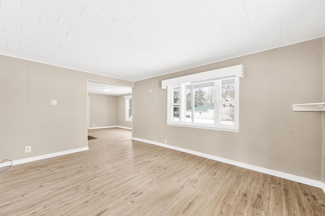 empty room with light hardwood / wood-style flooring