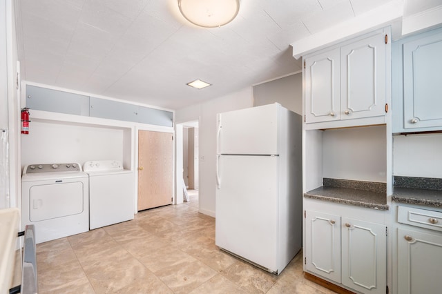 interior space with separate washer and dryer and white refrigerator