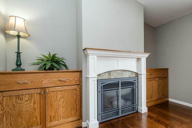 room details featuring a tile fireplace and hardwood / wood-style floors