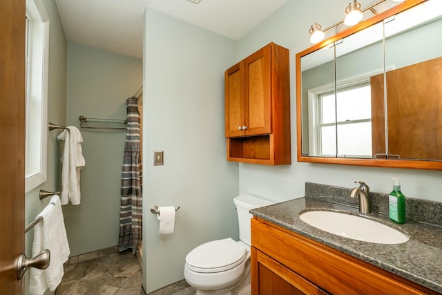 bathroom with vanity, a shower with curtain, and toilet