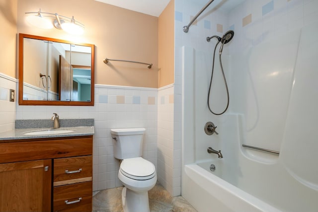 full bathroom with toilet, tile walls, vanity, shower / bath combination, and tile patterned flooring