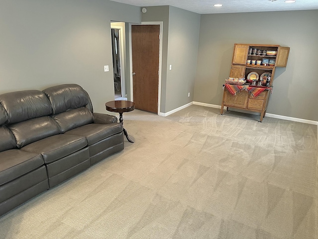 carpeted living room with a textured ceiling