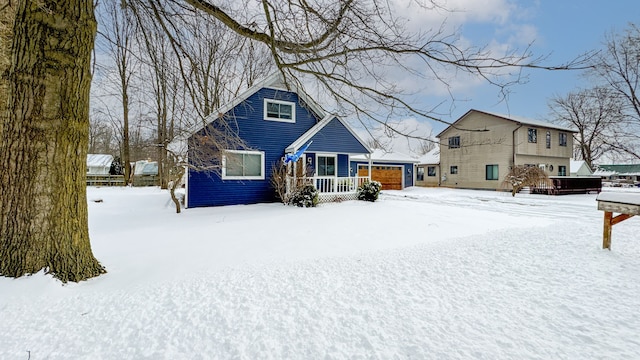 snow covered property featuring a garage