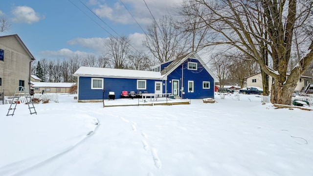 view of snow covered rear of property