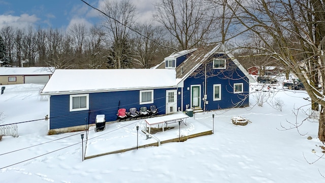 view of snow covered rear of property